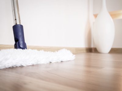 Service of cleaning hardwood floor from dust with white mop in house